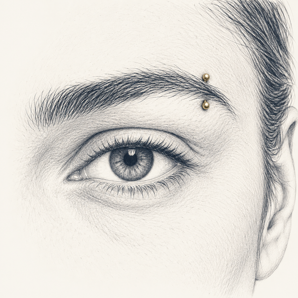 Anatomical pencil sketch showing jewelry worn through the outer eyebrow